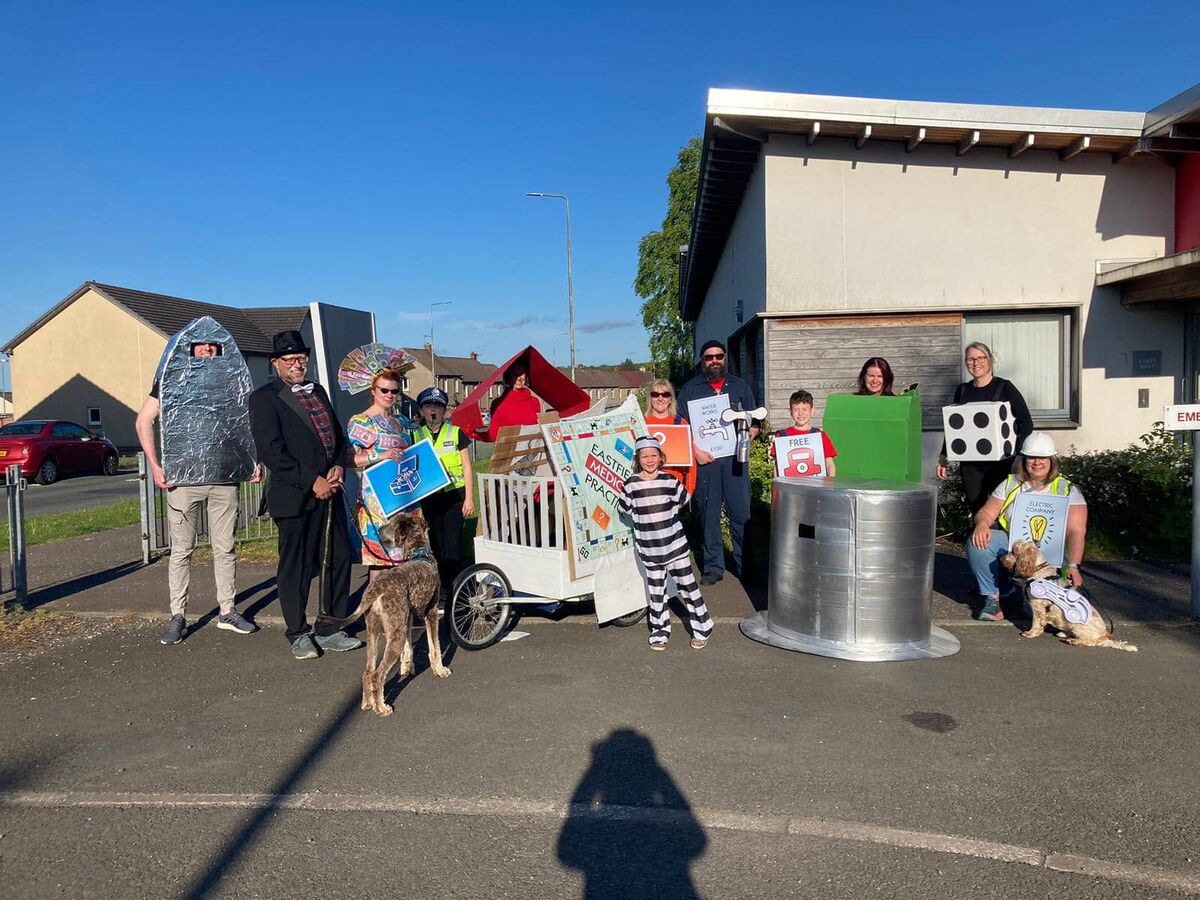 Staff and family members dressed as Monopoly pieces outside the practice