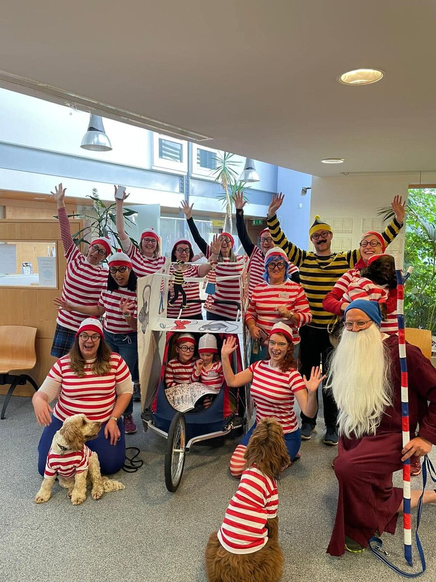 The practice team, including two dogs, dressed as Where's Wally characters in reception